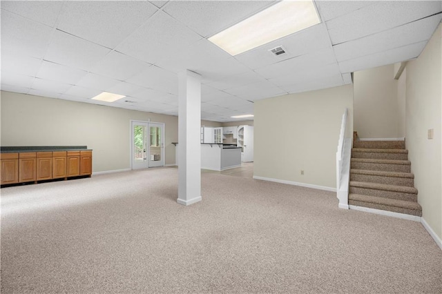 5065 Nesbit Ferry Ln, Atlanta, GA 30350 - below grade area with a paneled ceiling, light carpet, and stairway