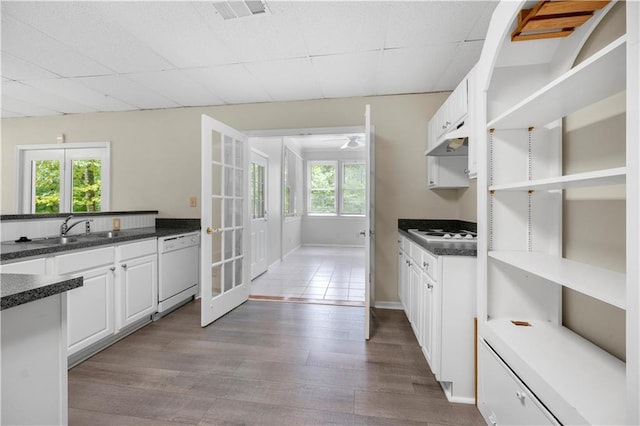 5065 Nesbit Ferry Ln, Atlanta, GA 30350 - kitchen with white appliances, french doors, dark countertops, dark wood-style floors, and white cabinets