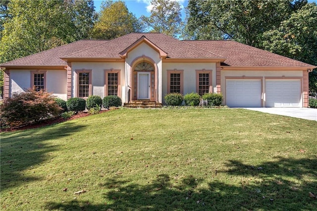 view of front facade with concrete driveway, a front yard, an attached garage, and stucco siding