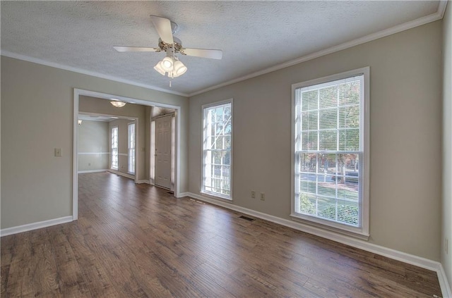 spare room featuring dark wood-type flooring, visible vents, crown molding, and a textured ceiling