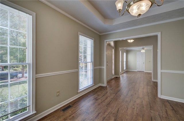 interior space with plenty of natural light, wood finished floors, visible vents, and baseboards