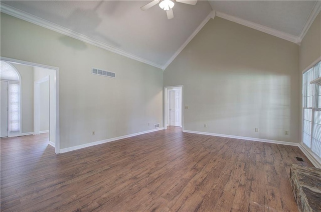 spare room featuring crown molding, visible vents, dark wood finished floors, and ceiling fan