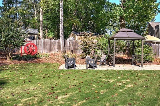 view of yard featuring a patio area, fence, and a gazebo