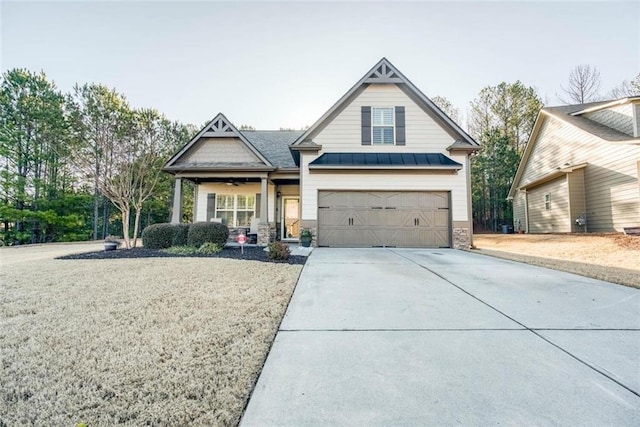 craftsman inspired home featuring a garage and covered porch