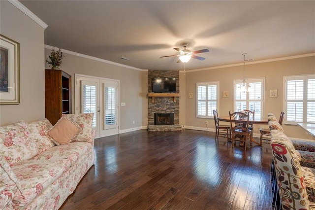 living room featuring crown molding, a fireplace, plenty of natural light, and dark hardwood / wood-style flooring