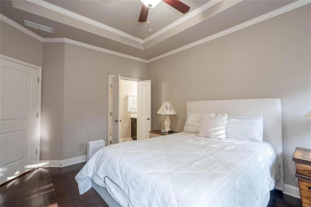 bedroom featuring hardwood / wood-style floors, ornamental molding, a raised ceiling, and ceiling fan