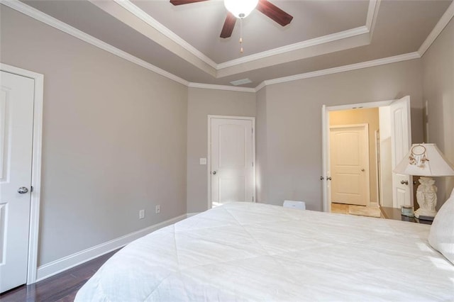 bedroom featuring crown molding, ceiling fan, a raised ceiling, and hardwood / wood-style floors