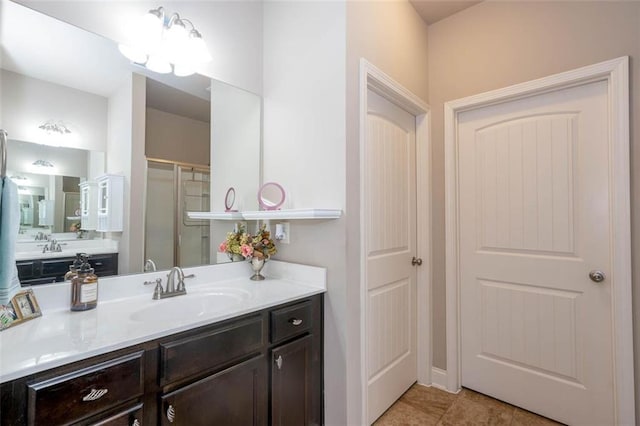 bathroom with vanity, tile patterned flooring, and a shower with door