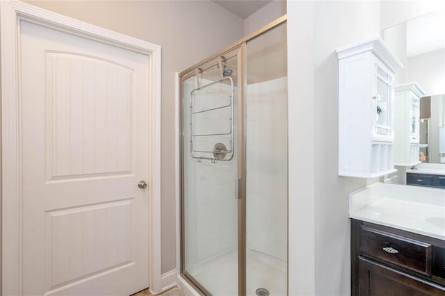 bathroom with vanity and a shower with shower door