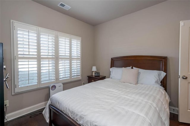 bedroom with dark wood-type flooring