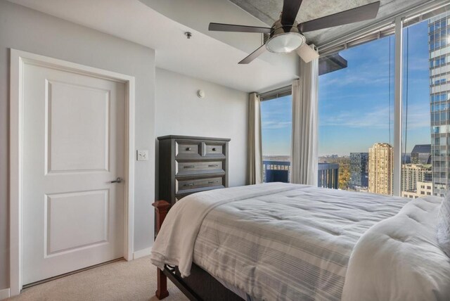 bedroom with ceiling fan and light carpet