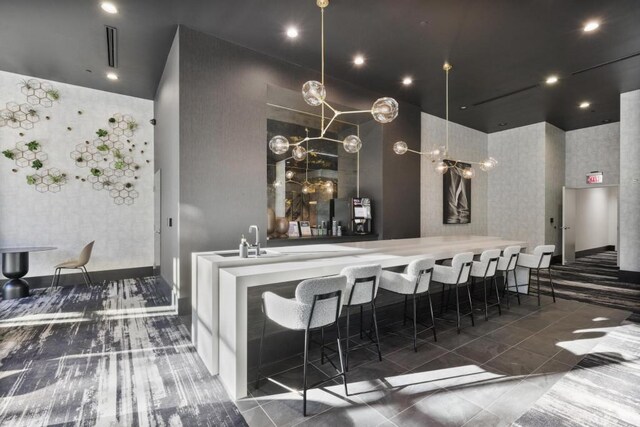 bar featuring dark tile patterned floors and sink