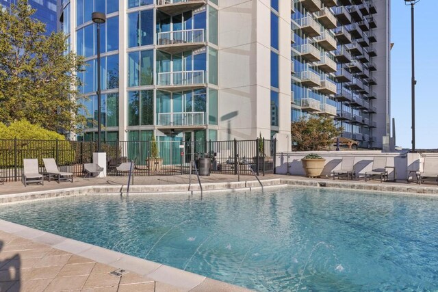 view of swimming pool with pool water feature