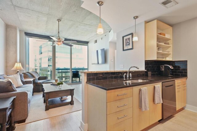 kitchen featuring kitchen peninsula, light brown cabinetry, light wood-type flooring, sink, and dishwasher