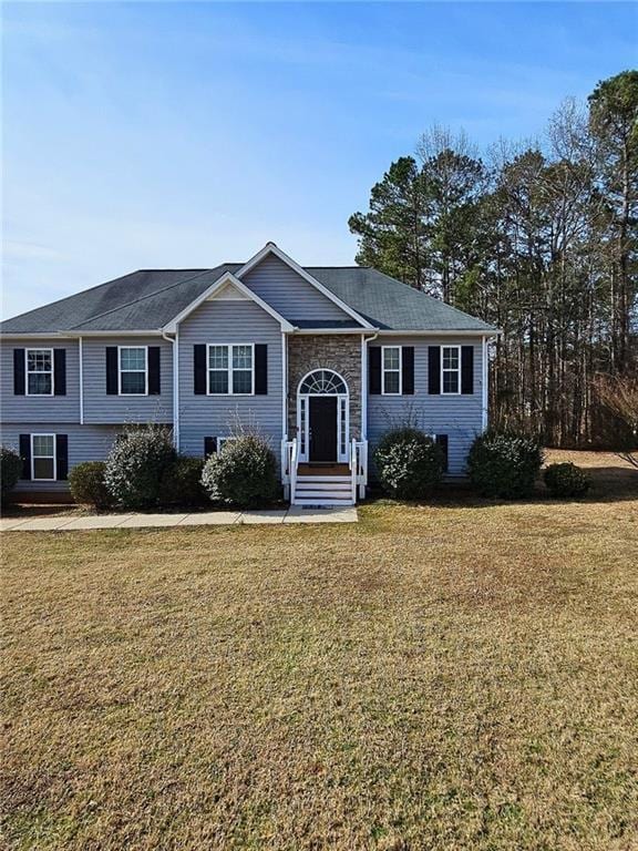 raised ranch with a front yard