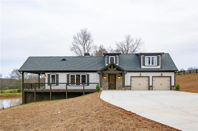 view of front of home with a wooden deck and a front yard