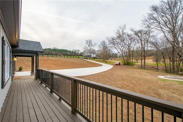 wooden terrace with a lawn