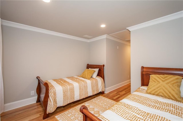 bedroom featuring crown molding and light wood-type flooring