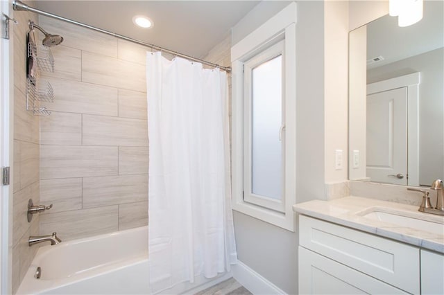 bathroom with vanity and shower / tub combo