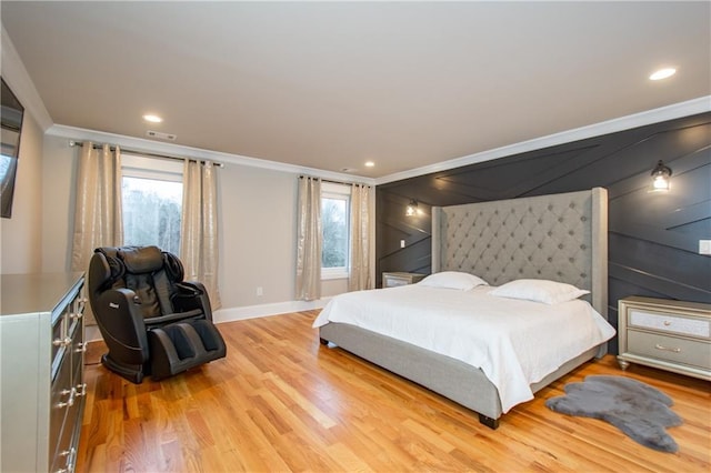 bedroom with crown molding and light wood-type flooring