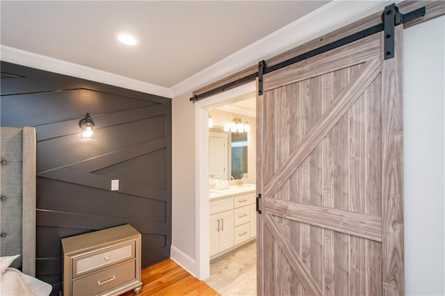 bathroom with hardwood / wood-style flooring, vanity, and crown molding