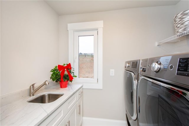 laundry room with cabinets, sink, and washing machine and clothes dryer