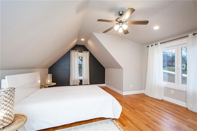 bedroom featuring hardwood / wood-style floors, vaulted ceiling, and ceiling fan