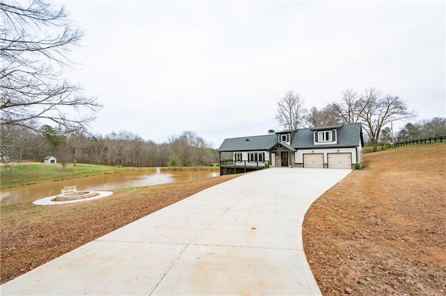 view of front facade featuring a garage and a water view