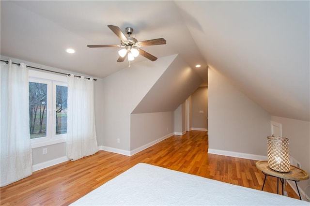 unfurnished bedroom featuring hardwood / wood-style flooring, ceiling fan, and vaulted ceiling