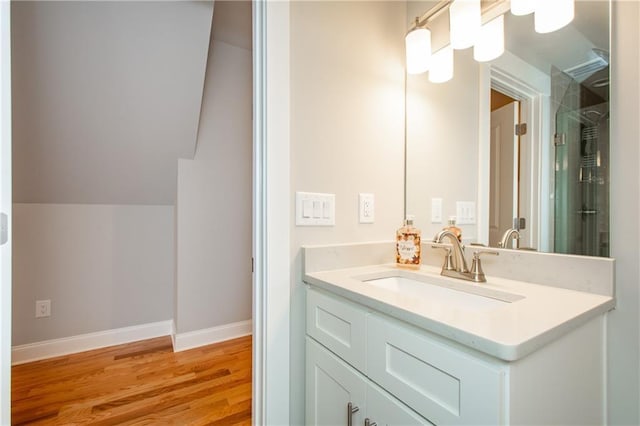 bathroom with vanity and wood-type flooring