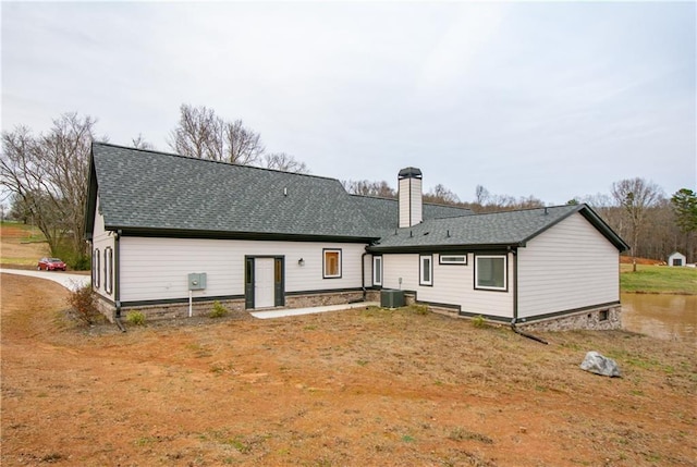 back of house featuring central AC and a yard