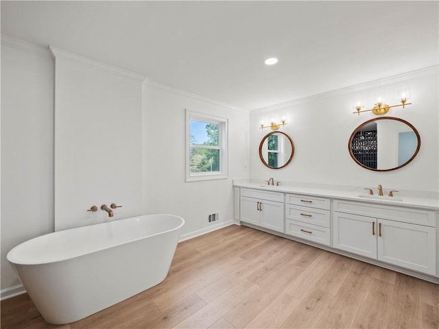 full bathroom featuring crown molding, visible vents, wood finished floors, a sink, and double vanity
