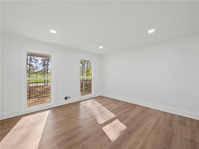 spare room with visible vents, baseboards, recessed lighting, and wood finished floors