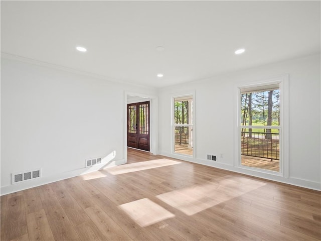 empty room with visible vents, light wood finished floors, and recessed lighting