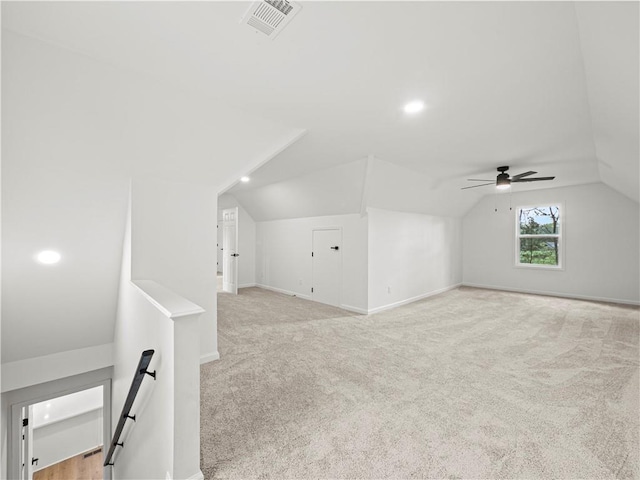 additional living space with visible vents, baseboards, a ceiling fan, carpet, and lofted ceiling