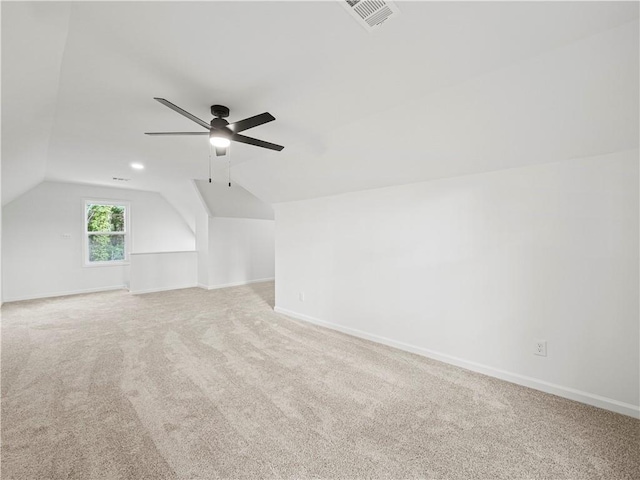 bonus room with light carpet, ceiling fan, baseboards, and lofted ceiling