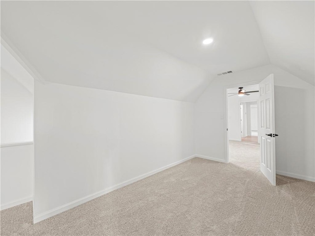 bonus room with light carpet, visible vents, baseboards, and vaulted ceiling