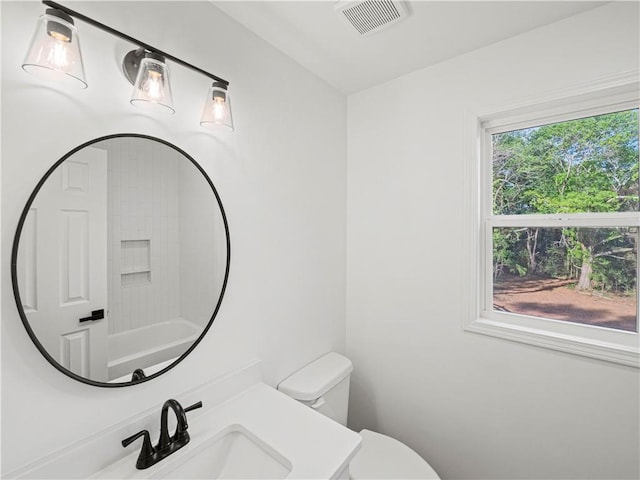 bathroom with vanity, visible vents, and toilet
