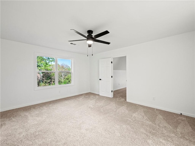 unfurnished room featuring light carpet, ceiling fan, baseboards, and visible vents