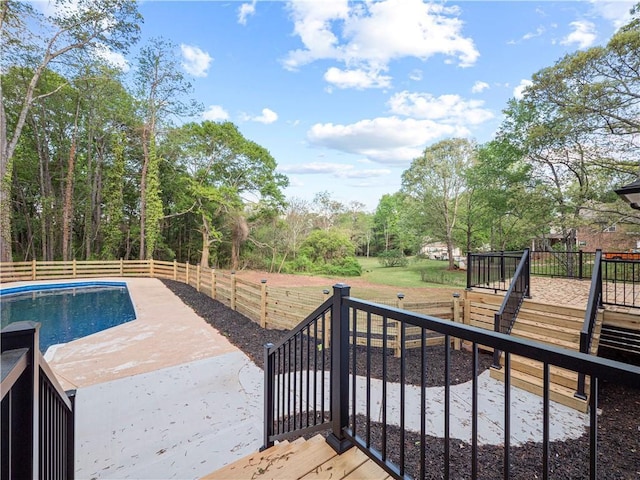 exterior space featuring a fenced in pool, a patio, stairway, a deck, and fence