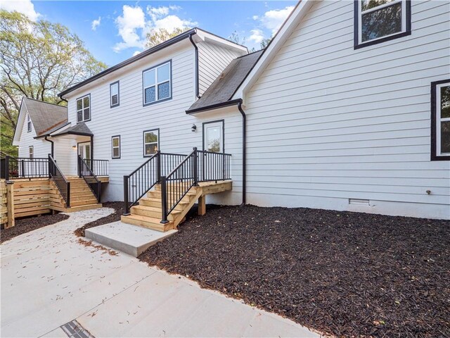 back of property featuring crawl space