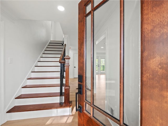 staircase with recessed lighting and wood finished floors