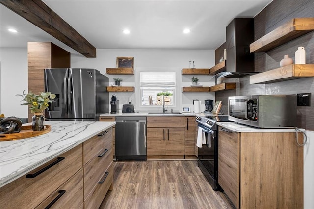 kitchen featuring open shelves, a sink, dark wood finished floors, stainless steel appliances, and light stone counters