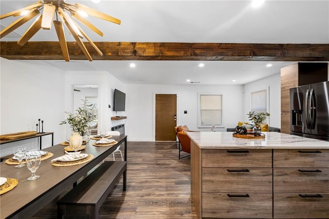 kitchen with stainless steel refrigerator with ice dispenser, dark wood-style flooring, modern cabinets, and beam ceiling