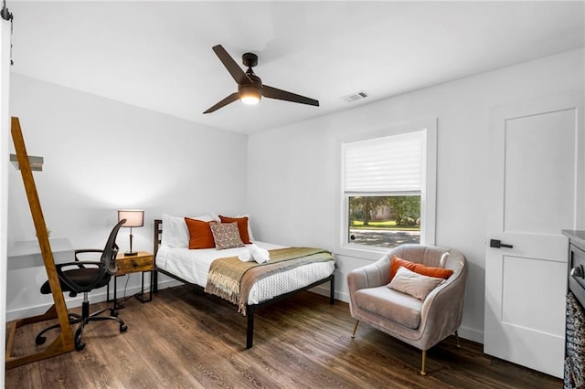bedroom featuring visible vents, ceiling fan, wood finished floors, and baseboards