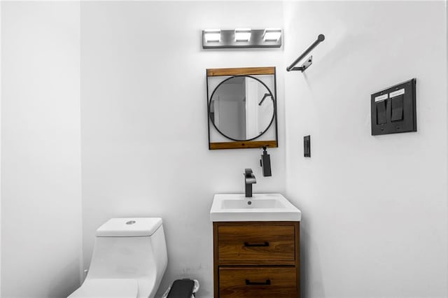 bathroom featuring toilet and vanity