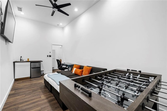 misc room featuring visible vents, a ceiling fan, recessed lighting, a towering ceiling, and wood finished floors