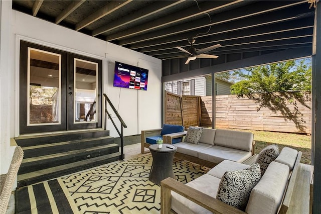 exterior space featuring an outdoor living space, entry steps, fence, and french doors