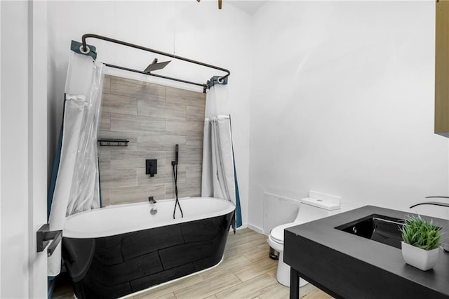 full bathroom with a shower with curtain, toilet, a bath, a sink, and wood finished floors