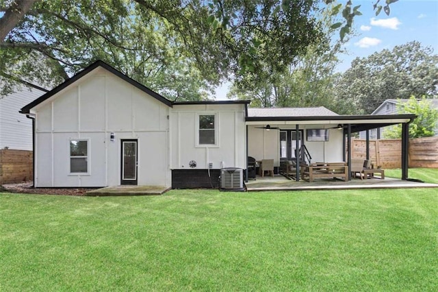back of house with a patio area, fence, and a lawn